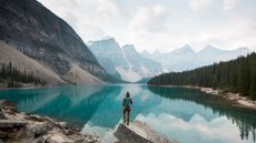 girl with mountains as a backdrop depicting where to go for amazing hikes across the globe