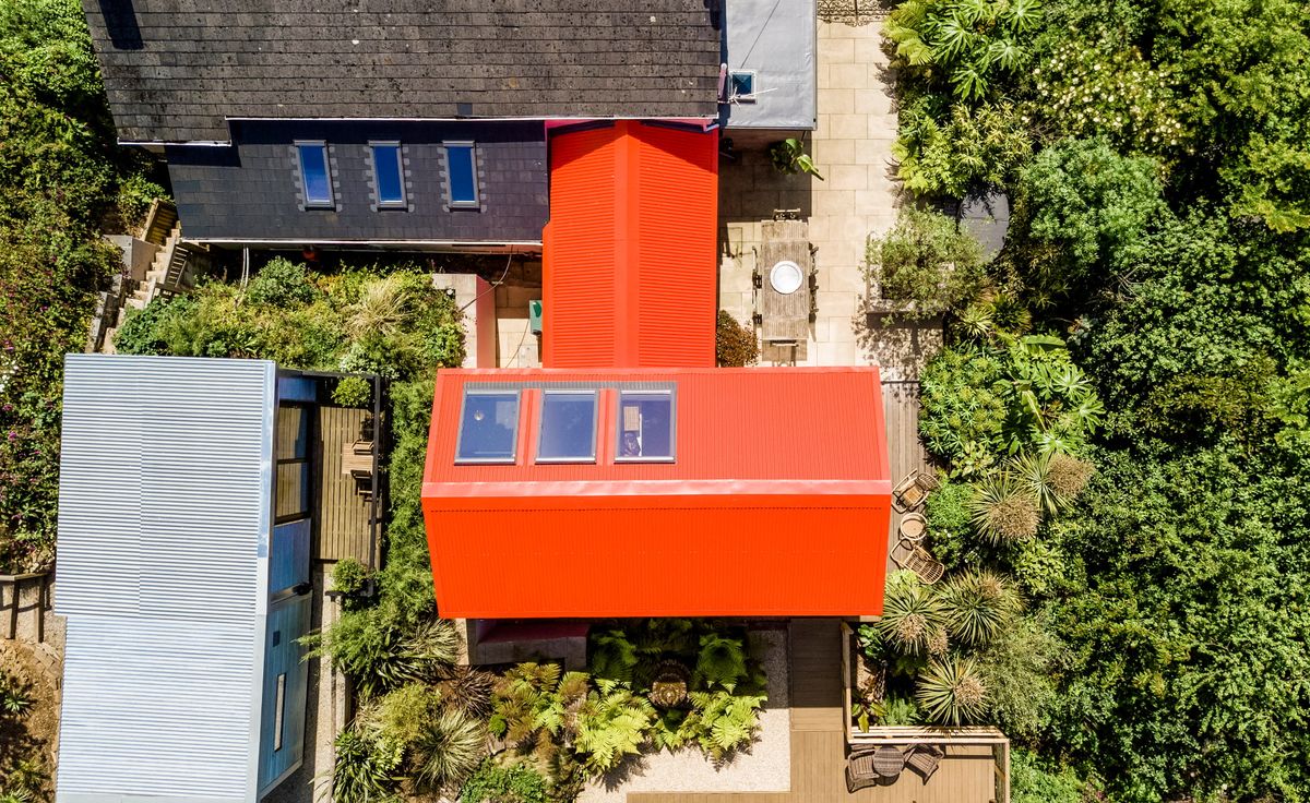Orange extension with skylights attached to a cottage