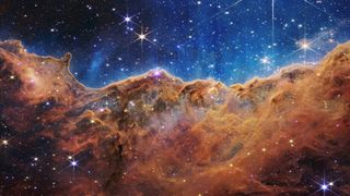 This landscape of "mountains" and "valleys" speckled with glittering stars is actually the edge of a nearby, young, star-forming region called NGC 3324 in the Carina Nebula. Captured in infrared light by NASA’s new James Webb Space Telescope, this image reveals for the first time previously invisible areas of star birth.