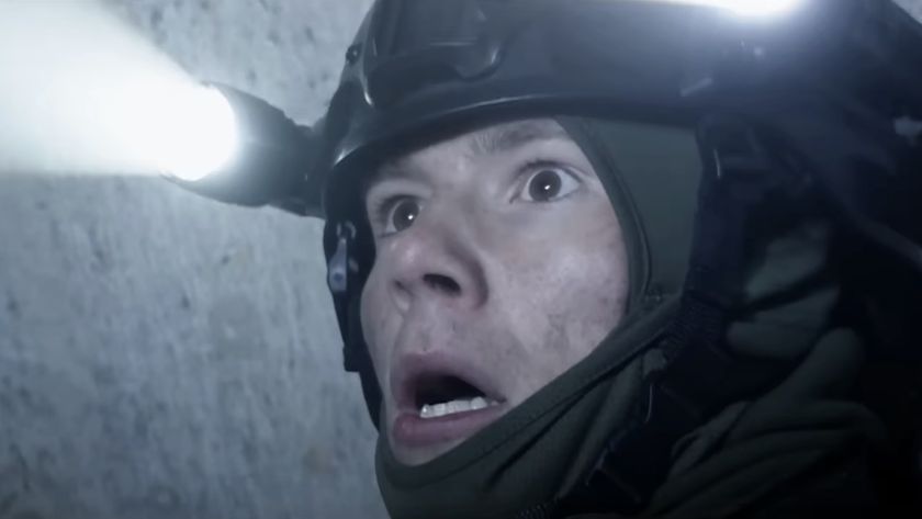 Close-up of wide-eyed soldier with helmet lights in 28 Years Later