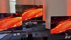 The Future C64, C74 and C84 series TVs on display at their launch event, and showing a stream of molten lava