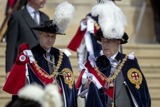 Prince William, Duke of Cambridge and Prince Andrew, Duke of York talk as they leave St George's Chapel after attending the annual Order of the Garter Service