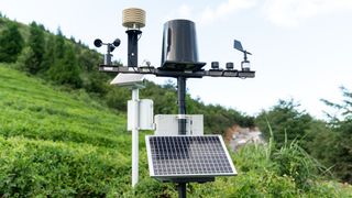 A home weather station working in someone's garden