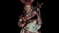 Arc Raiders character in witch huntress skin holding a shotgun in the dark