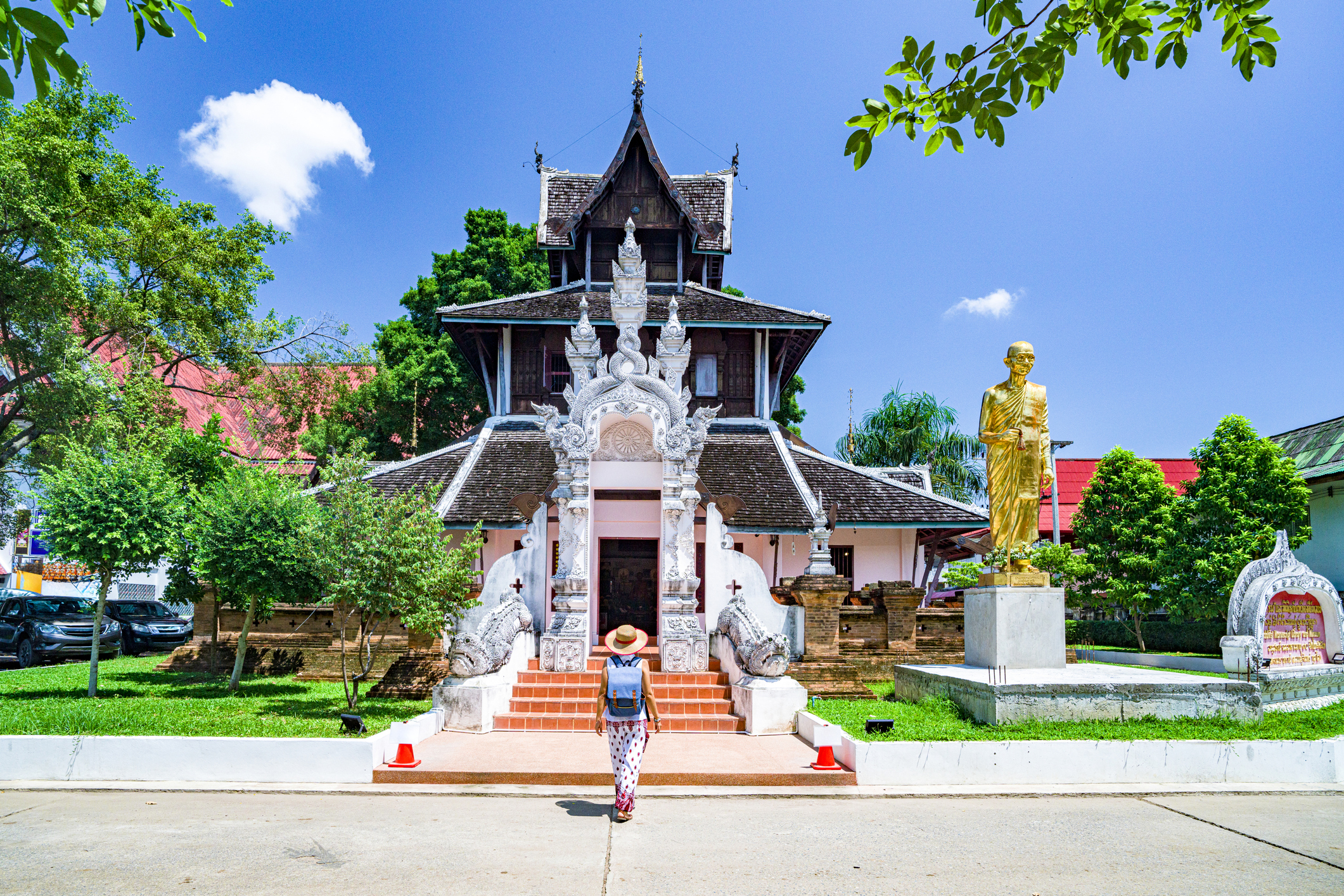 Mature woman walking towards an old pagoda, Wat Chedi Luang Temple, Chiang Mai, Thailand