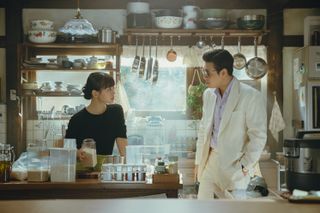 A woman (Go Min-si) and a man (Kang Ha-neul) stand in a kitchen, in 'Tastefully Yours.'