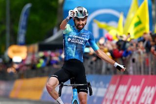 Valentin Paret-Peintre celebrates his 2024 Giro d'Italia stage win atop the Bocca della Selva