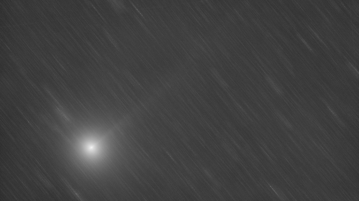 a black and white photograph of a comet streaking through space