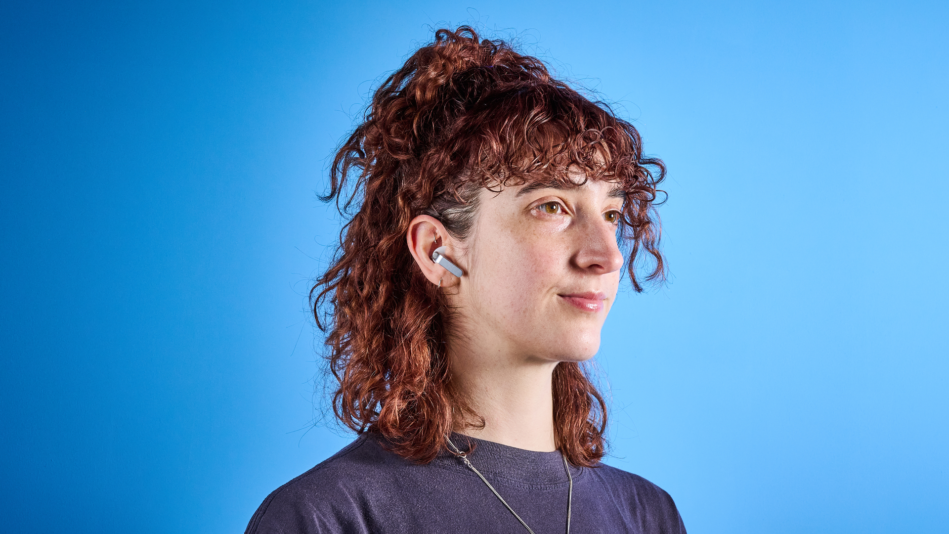 the samsung galaxy buds 4 photographed against the blue tom's guide background showing charging case and buds
