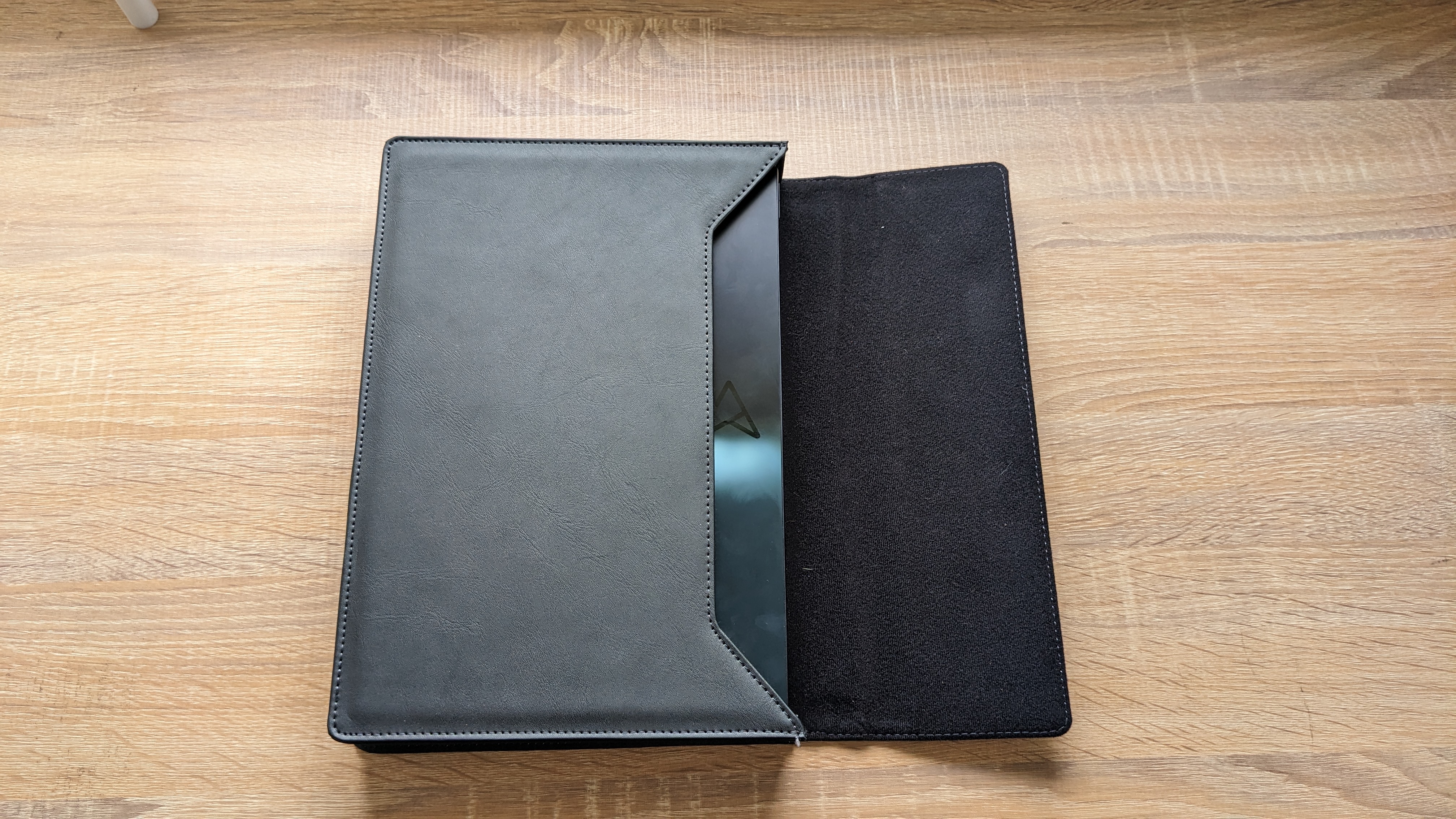 The Asus Zenbook 17 Fold OLED pictured on a wooden desk.