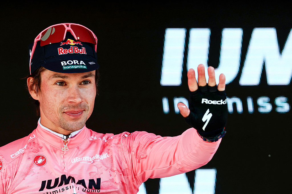 Red Bull-Bora-Hansgrohe&#039;s Slovenian rider Primoz Roglic wearing the overall leader&#039;s pink jersey (Maglia Rosa) waves on the podium after the second stage of the 108th Giro d&#039;Italia cycling race, a 13.7km individual time-trial from Tirana to Tirana in Albania, on May 10, 2025. (Photo by Luca Bettini / AFP)