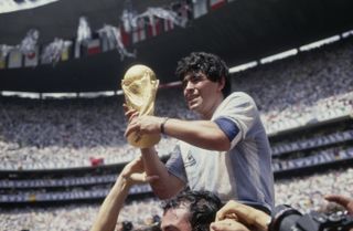 Diego Maradona celebrates with the World Cup trophy after Argentina's win over West Germany in the 1986 final at Mexico City's Estadio Azteca.