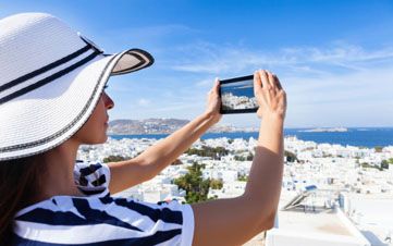 Beautiful woman taking photo with a digital tablet