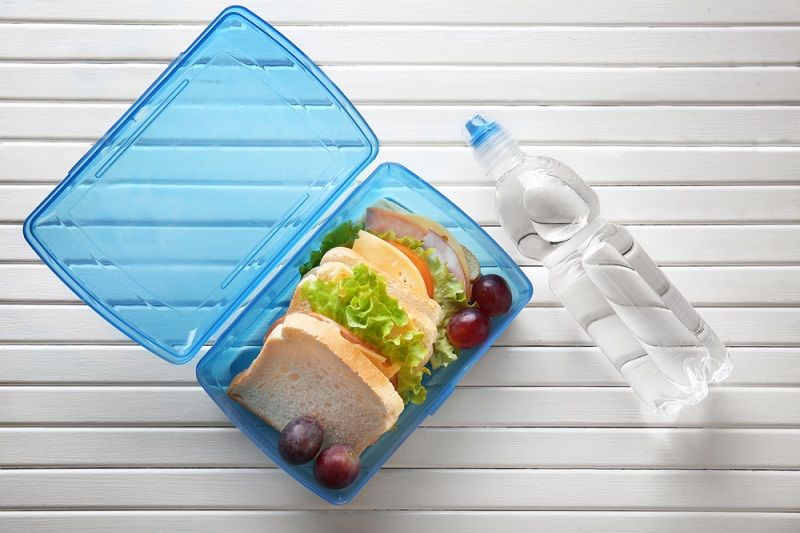 An image of a plastic bottle and plastic lunchbox.