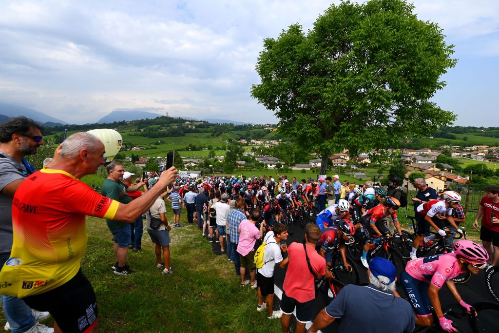 TREVISO ITALY MAY 26 A general view of Richard Carapaz of Ecuador and Team INEOS Grenadiers pink leader jersey and the peloton beginning to climb the Muro di Ca del Poggio 237m while fans cheer during the 105th Giro dItalia 2022 Stage 18 a 156km stage from Borgo Valsugana to Treviso Giro WorldTour on May 26 2022 in Treviso Italy Photo by Tim de WaeleGetty Images