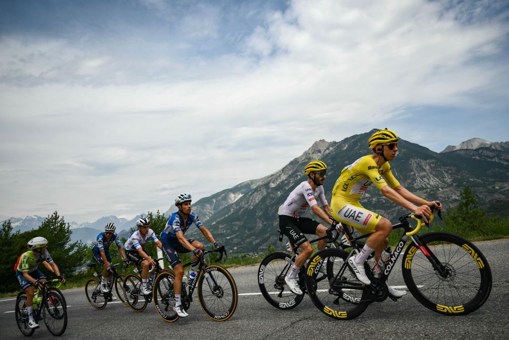 Tadej Pogacar wearing the overall leader&#039;s yellow jersey among the field at the Tour de France