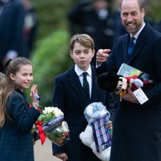 Princess Charlotte, Prince George, and Prince Louis carry gifts from royal fans at Sandringham as they stand with father Prince William on Christmas Day