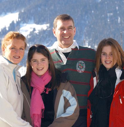 Sarah Ferguson, Prince Andrew, Princess Beatrice and Princess Eugenie posing in front of a snowy mountain in 2003