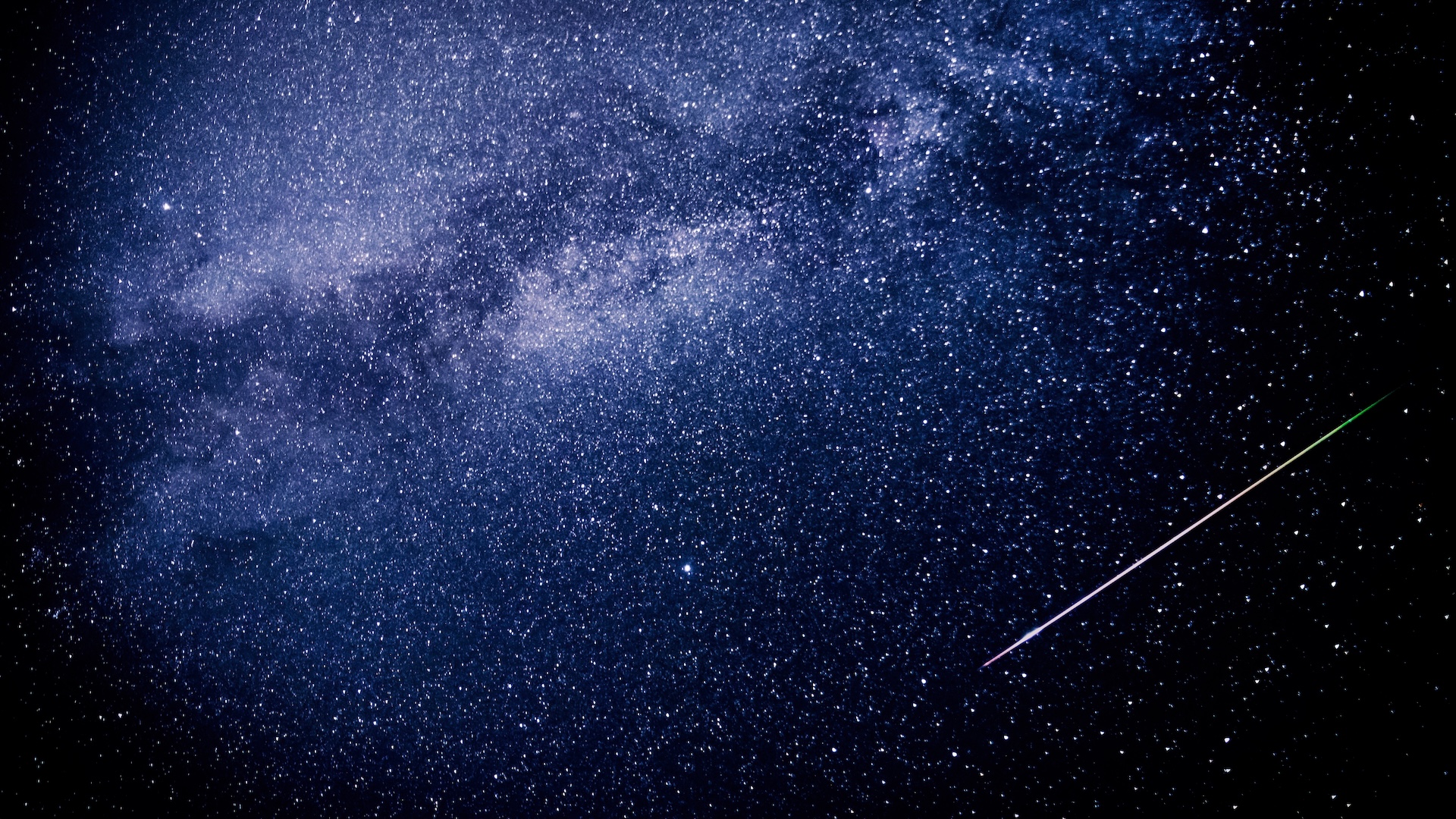 A photo of a meteor streaking through a starry night sky