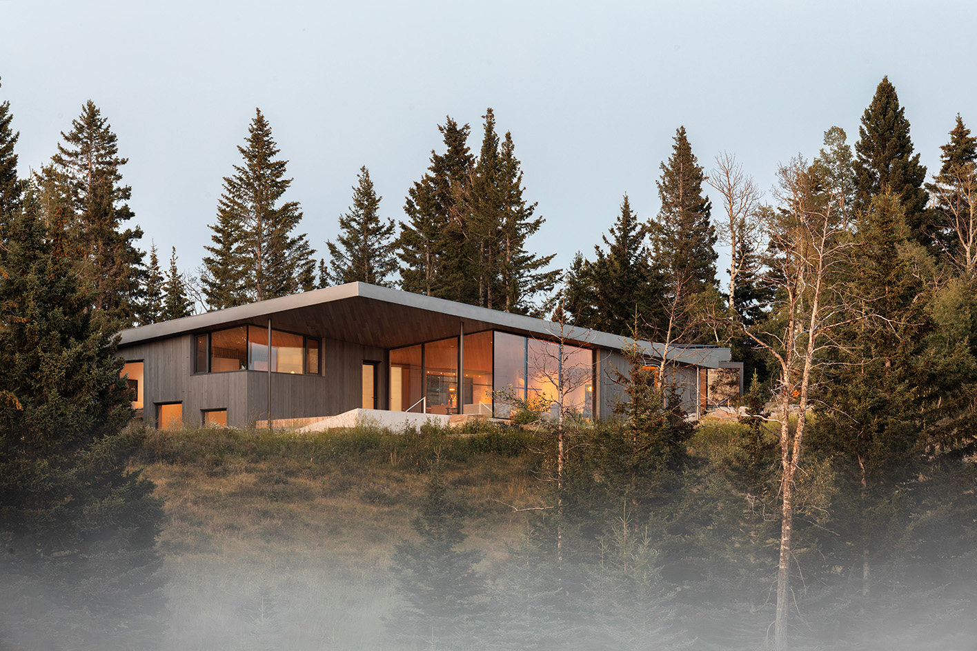 Cut Out House, a square footprint home with a round cut out set in the canadian winderness, by a lake