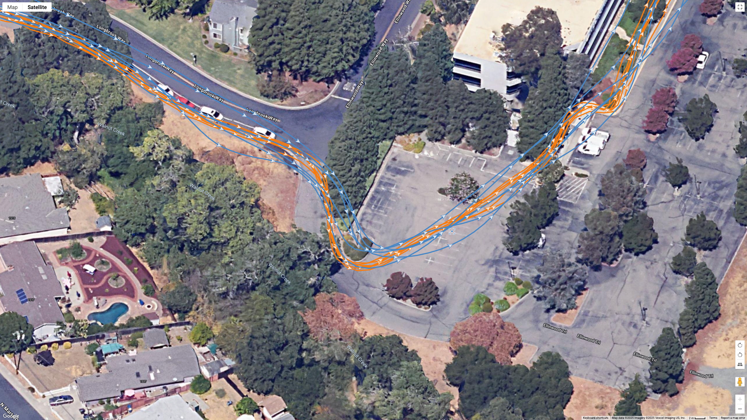 A Google Earth satellite map showing the GPS path of the Samsung Galaxy Watch 8 Classic (blue) and Garmin Forerunner 970 (orange) worn by the same runner.