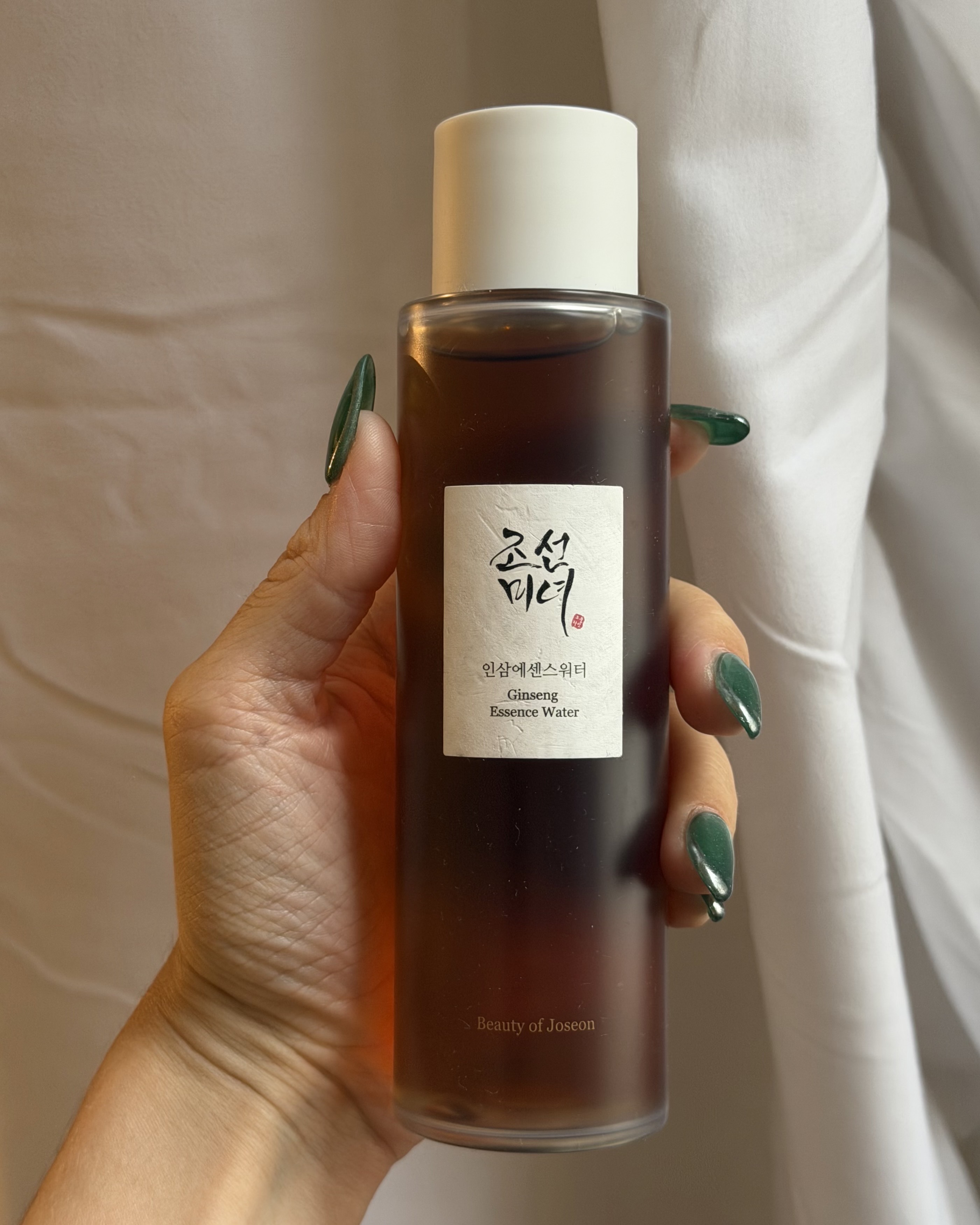 An image of Who What Wear associate beauty editor Alyssa Brascia holding the Beauty of Joseon Ginseng Essence Water.