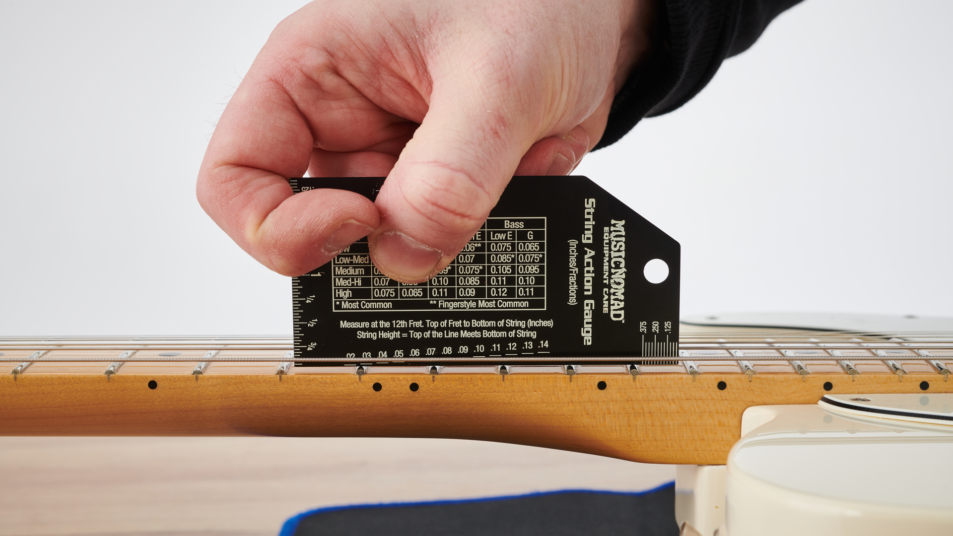 Measuring string action on an electric guitar