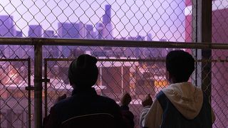 Two boys look out at a cityscape in "We Grown Now"