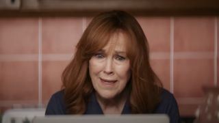 Catherine O'Hara sits frustrated in front of a computer screen in Argylle.