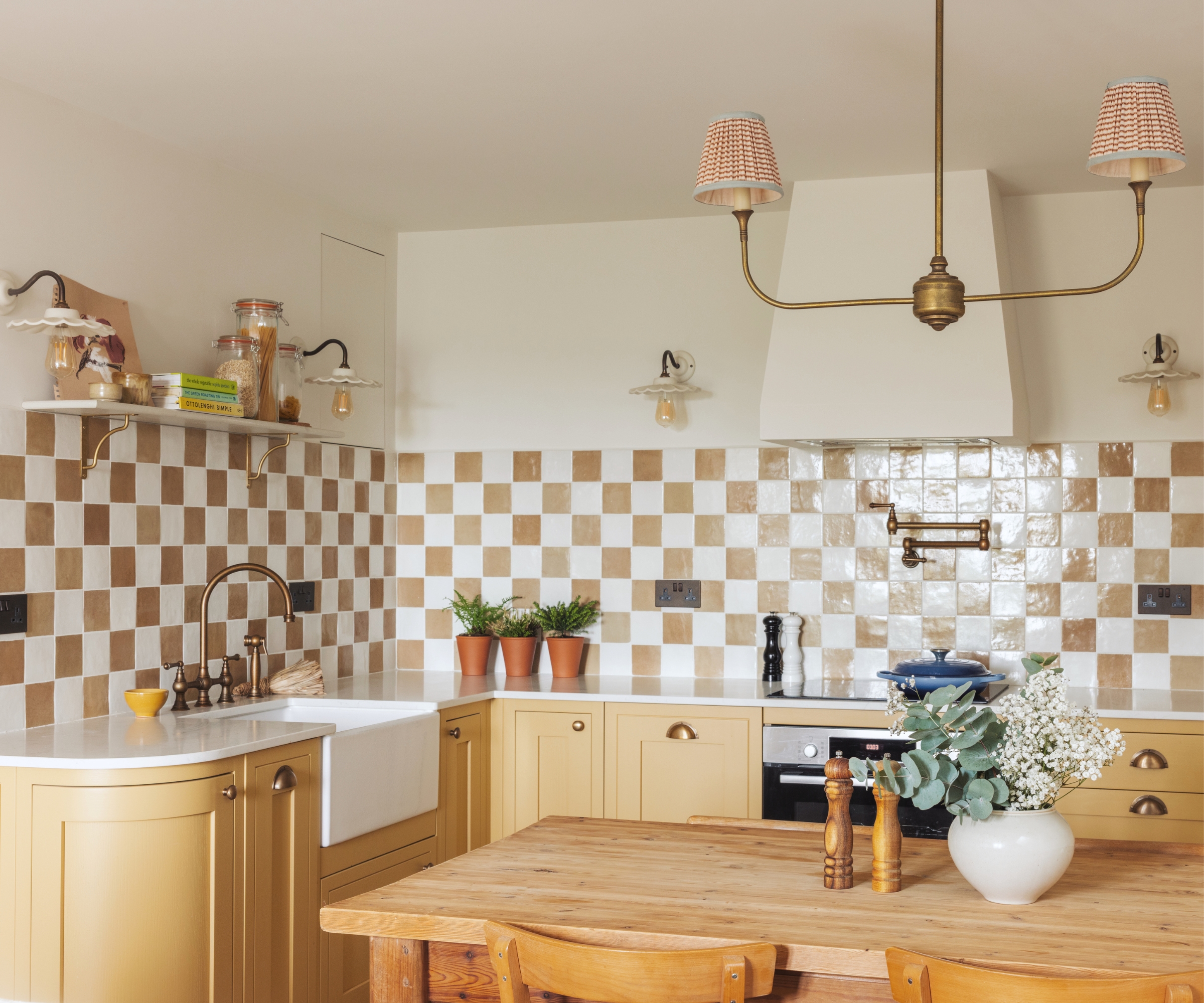 A pale yellow kitchen with checkerboard backsplash tiles