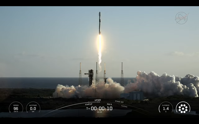 A black and white SpaceX rocket launches into a blue sky with NG-24.
