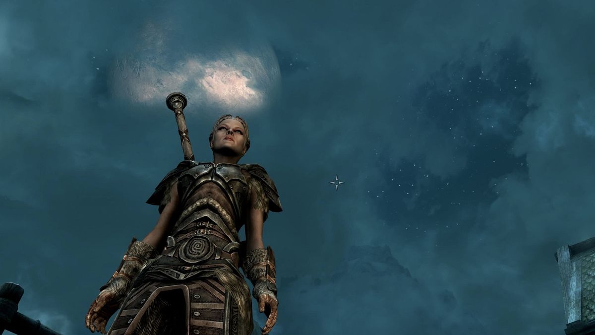 Skyrim screenshot showing the Dragonborn standing before a big full moon hanging in the sky 