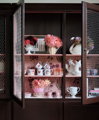 Pink and brown painted cabinet in a kitchen