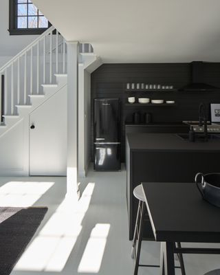 a black and white kitchen in a modern cottage