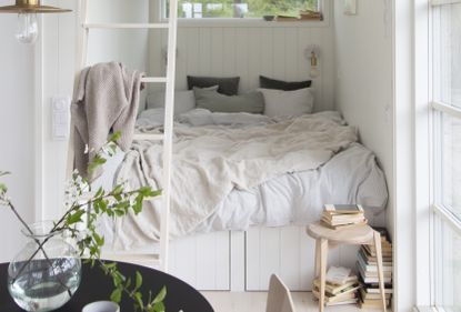 Bedroom nook with white panelling and under bed storage