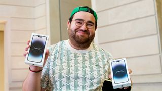 Person holding three iPhones