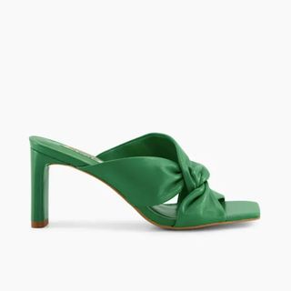 Still life shot of green high heel open toe mules