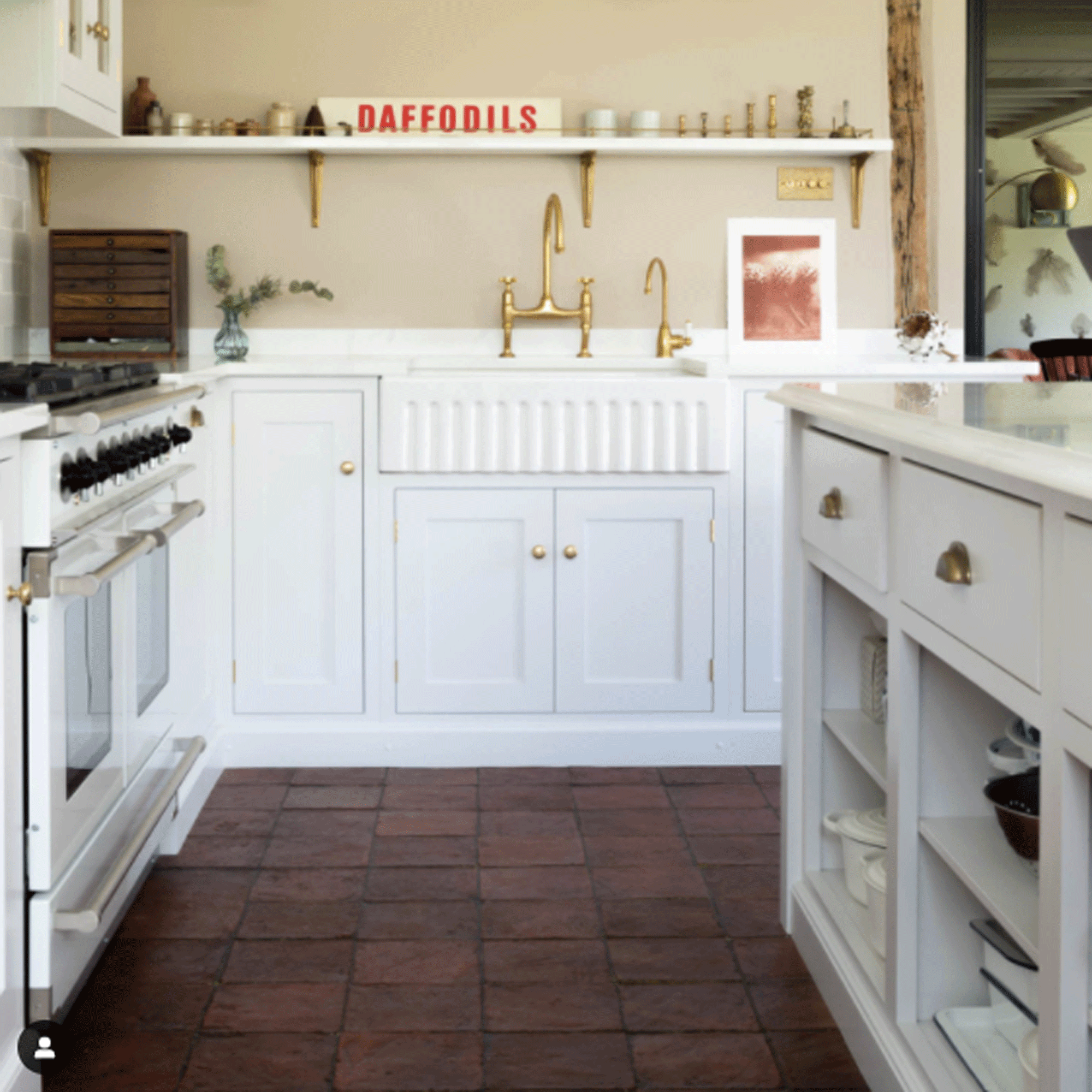 White kitchen with terracotta flooring