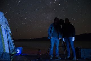 Steve Warwick, Northrop Grumman program manager for Starshade field testing, and Tiffany Glassman, astronomer and principal investigator for Starshade field testing, stand in the Starshade's shadow at the telescope station, demonstrating the technology's desired effect.