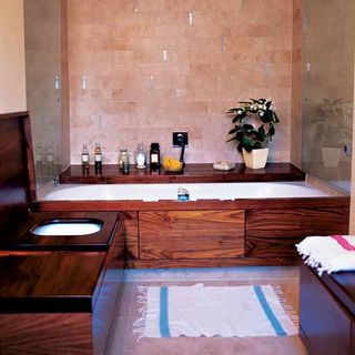 bathroom with wooden cover bathtub and commode and white pent pot