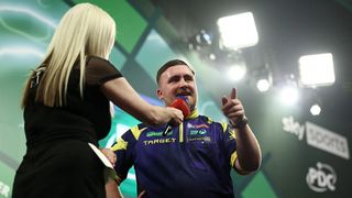 Luke Littler remonstrates with the crowd while being interviewed after his last 16 win at the PDC World Darts Championship 2026