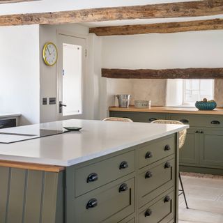 kitchen with green island and cabinetry