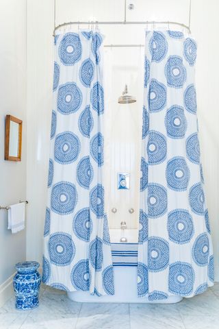 blue pattern shower curtain over a bath
