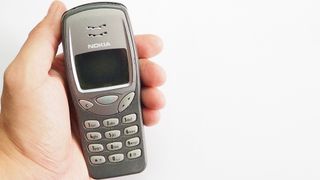 The Nokia 3210 classic phone in hand