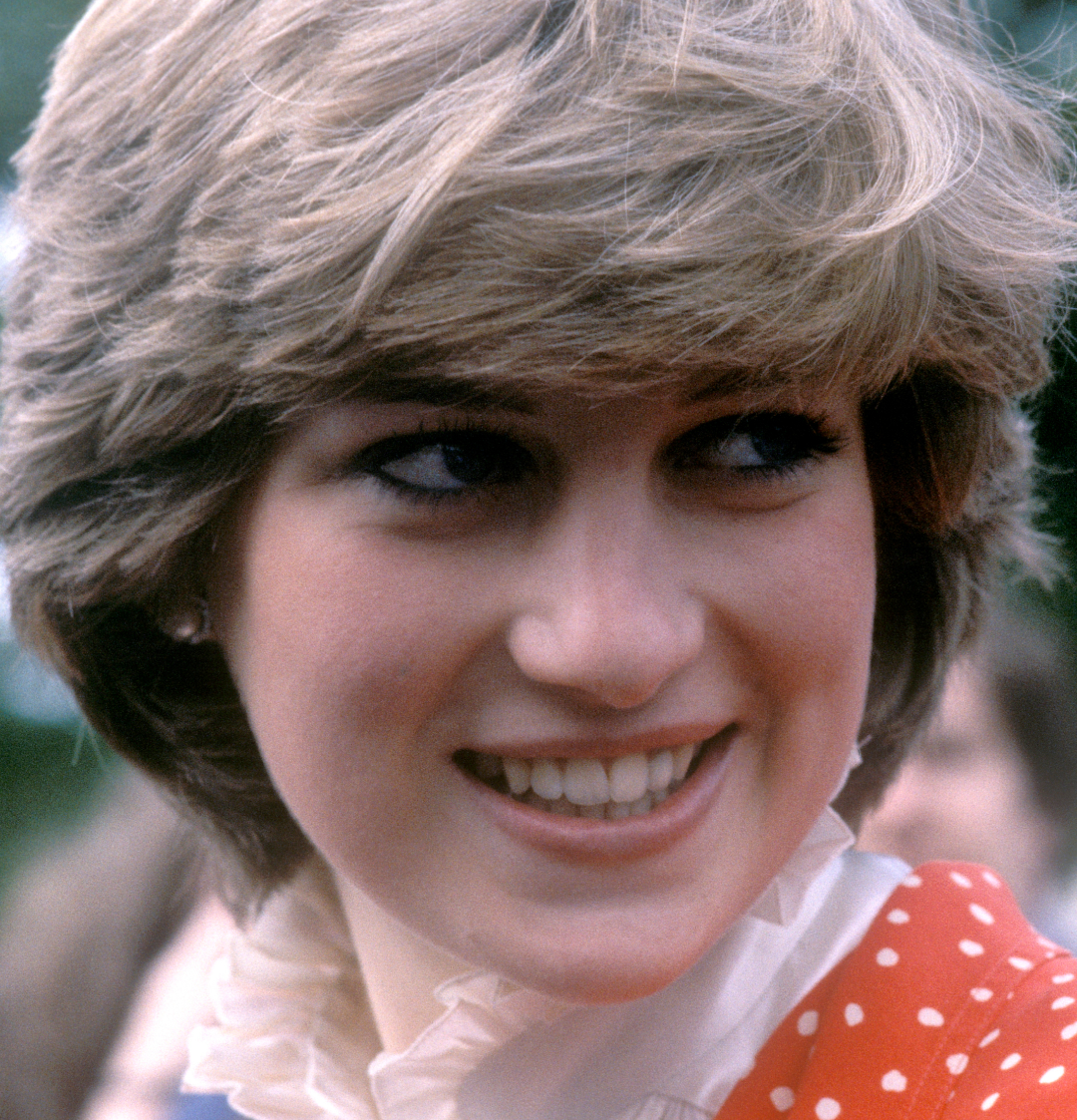 Princess Diana wearing a red polka dot dress smiling in 1981