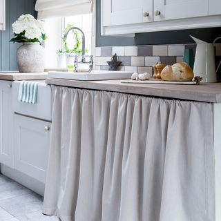 kitchen with white curtain and worktop