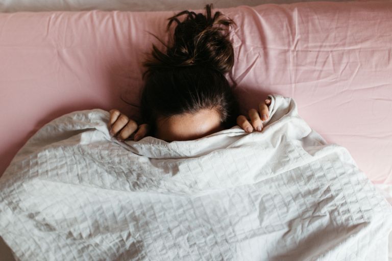 Sleep aids: Woman sleeping under duvet