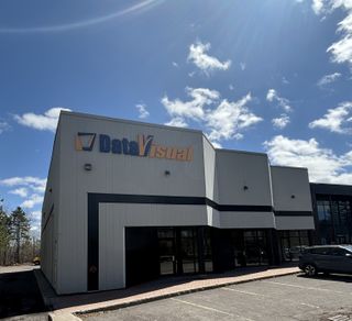 The DataVisual Marketing office building exterior on a sunny, blue-sky day.