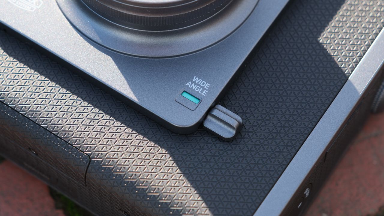 close up of wide angle lens toggle on a Fujifilm Instax Wide Evo