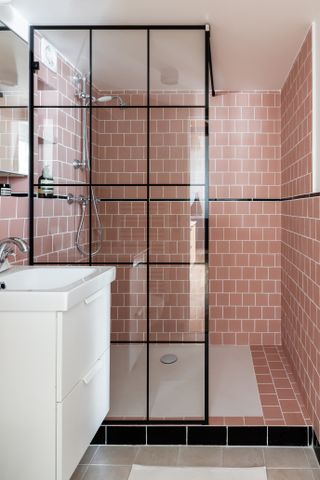 pink tiled shower with black accents